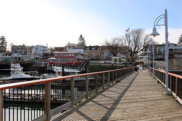 view down a boardwalk towards a port town