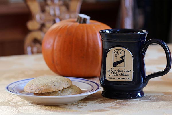 plate of cookies next to a mug and a small pumpkin